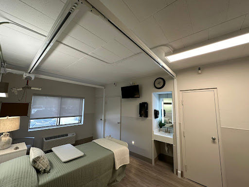 A cozy and modern room featuring a bed, a television, and an en-suite bathroom.