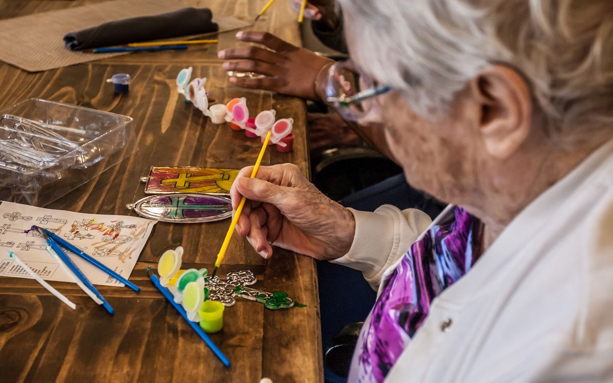 Seniors engaging in a painting and crafting activity.