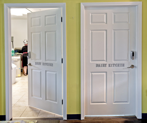 Two white doors labeled 'RESTROOM' leading to different bathroom facilities in a home.