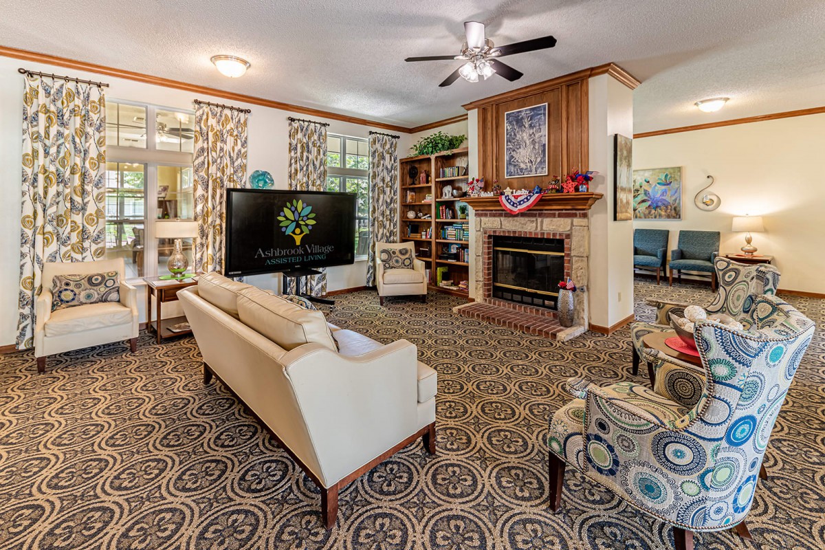 A cozy living room with a fireplace, television, and comfortable seating arrangement.