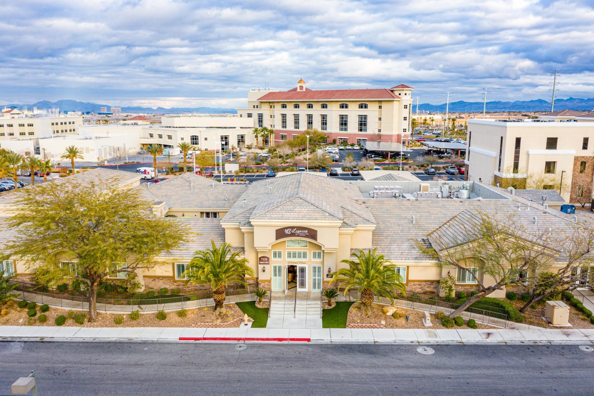 Aerial view of a building complex under a cloudy sky.