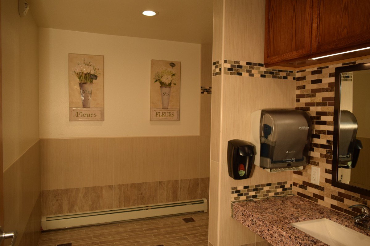 A well-decorated bathroom interior with a sink and hand dryer.