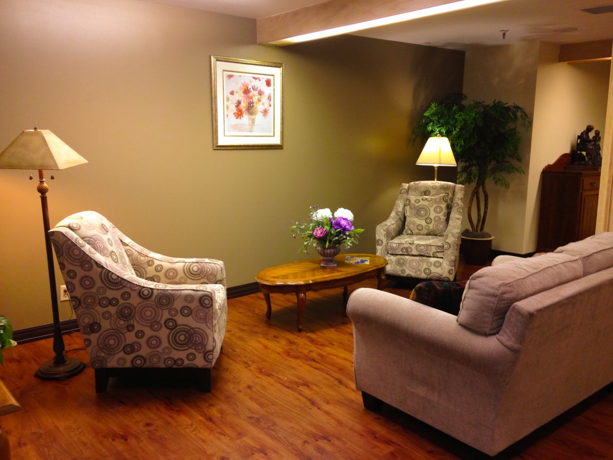 A cozy living room with comfortable chairs and warm lighting.