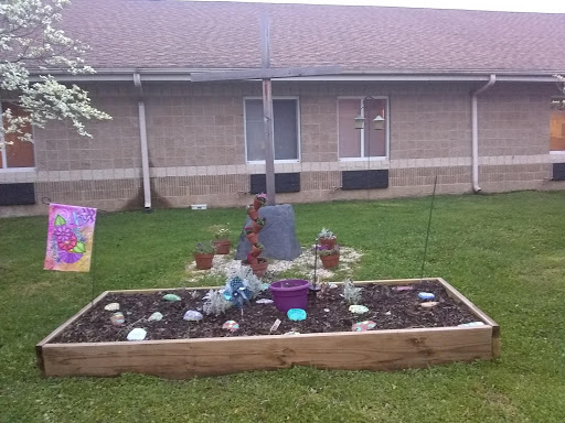 A beautifully arranged garden featuring decorative stones and a mix of plants.