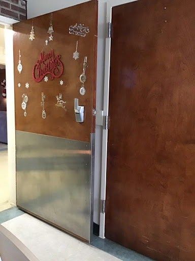 A decorative door with wooden and metal elements, possibly leading to a kitchen or storage area.