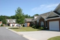 A suburban residential area with brick houses and driveways.