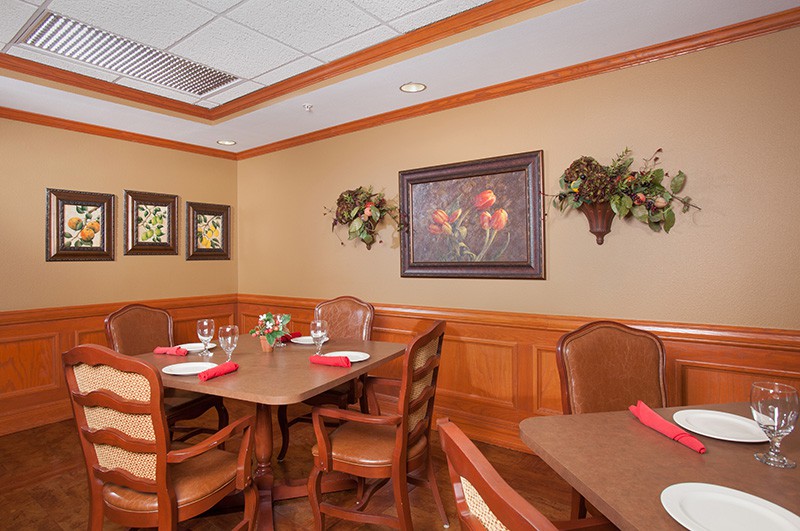 A cozy dining area with elegant decor and neatly set tables.
