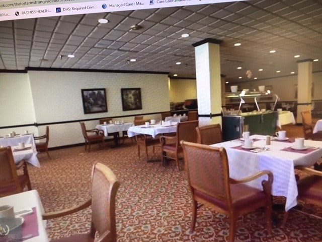 An empty restaurant dining area with neatly arranged tables and chairs.