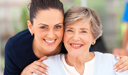 A joyful portrait of two women smiling together.