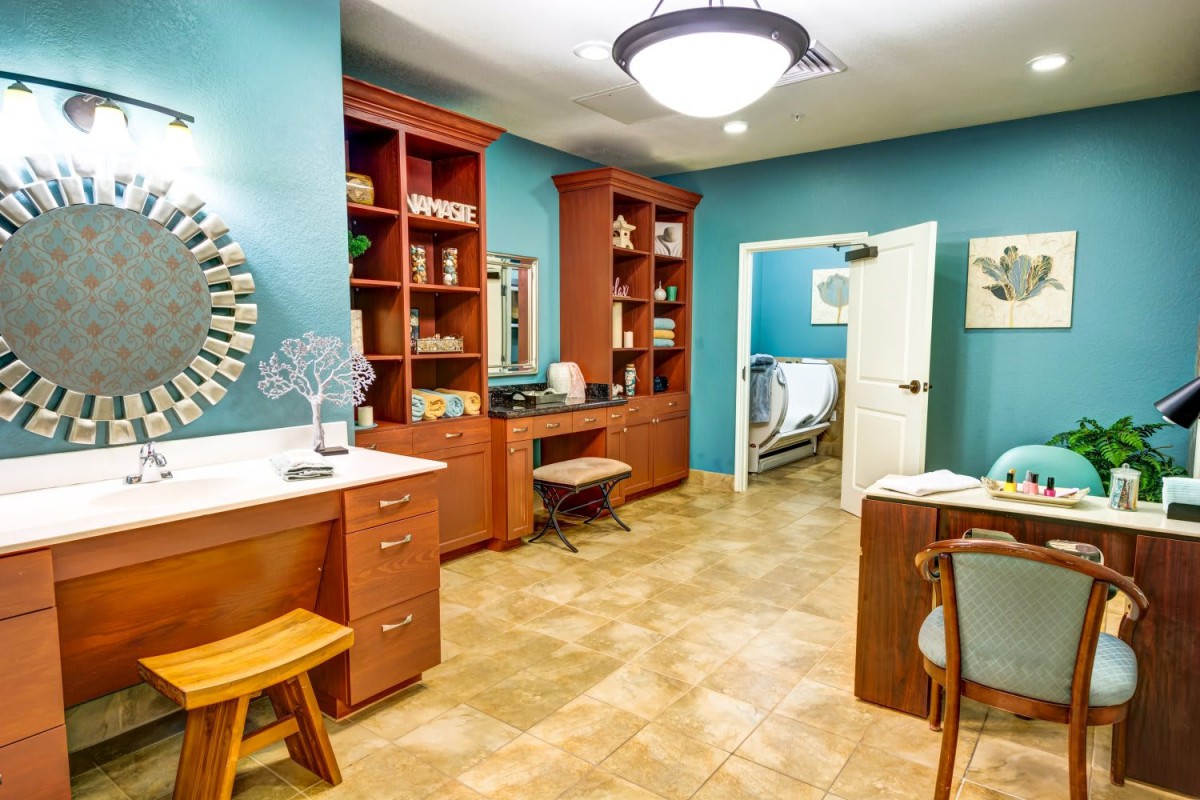 A modern study room with wooden furniture and built-in shelves.
