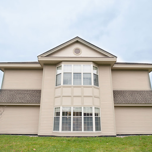 A modern two-story house with a large window design.