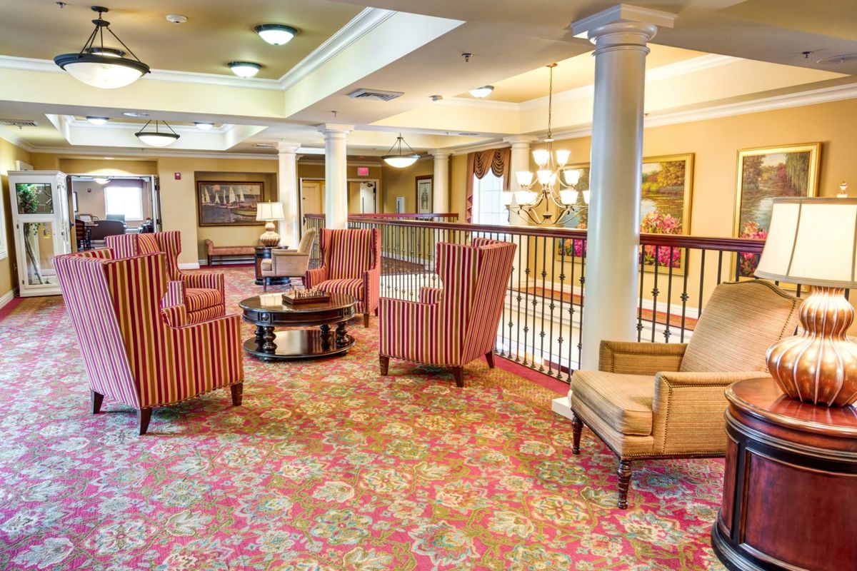 A spacious and elegantly designed lounge area with plush seating and ornate carpeting.