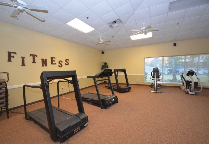 A fitness room with treadmills and exercise equipment.