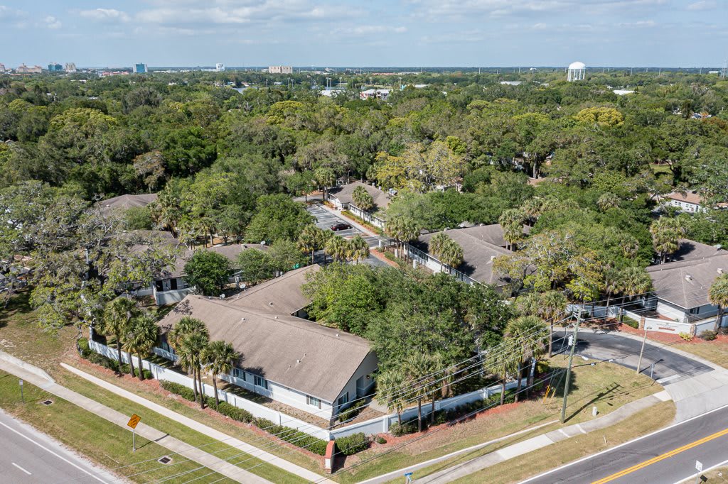 Aerial view of a suburban residential area surrounded by trees.