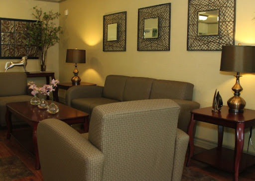 A cozy living room featuring a comfortable sofa, stylish chairs, and decorative elements.