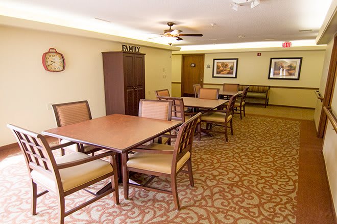 A well-lit dining area with tables and chairs arranged neatly.