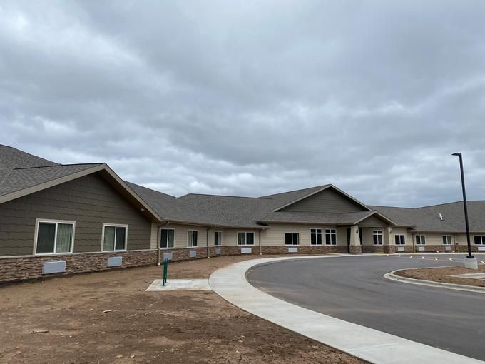 A newly constructed residential building under a cloudy sky.