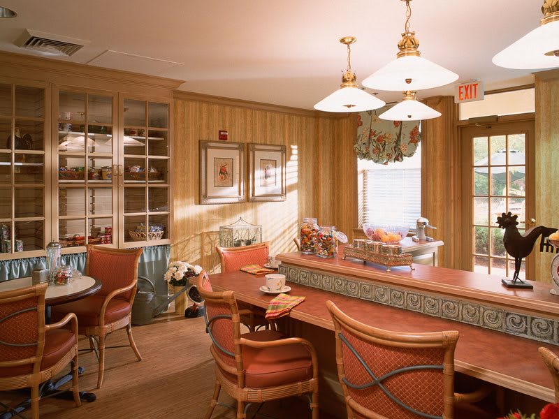 A cozy living room with a bar area, featuring comfortable seating and warm lighting.