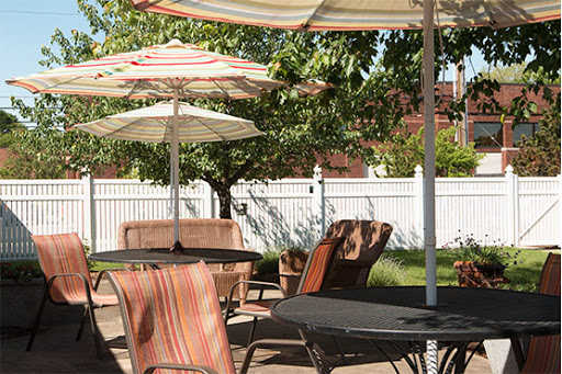 A peaceful outdoor patio setup with tables and umbrellas, perfect for relaxation.