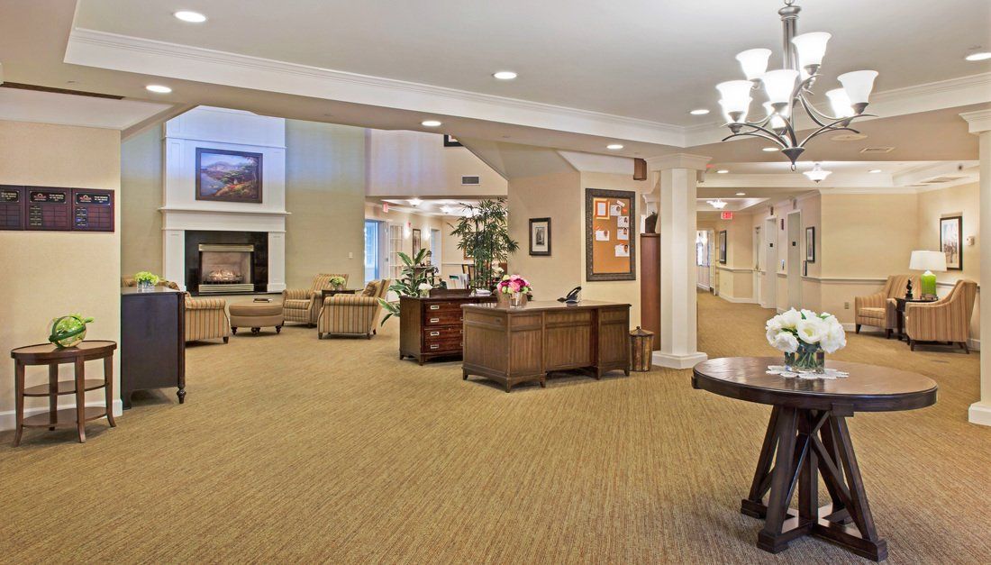 A spacious and well-decorated lobby area with comfortable seating and a reception desk.