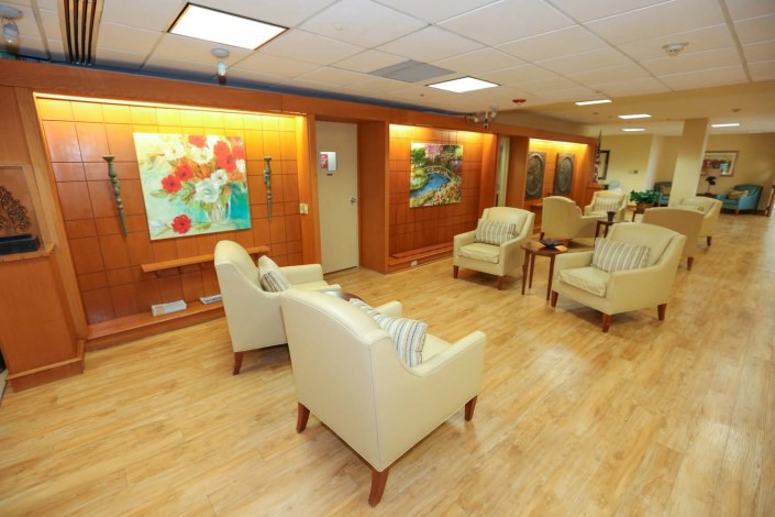 A well-lit waiting area with comfortable seating and colorful artwork on the walls.