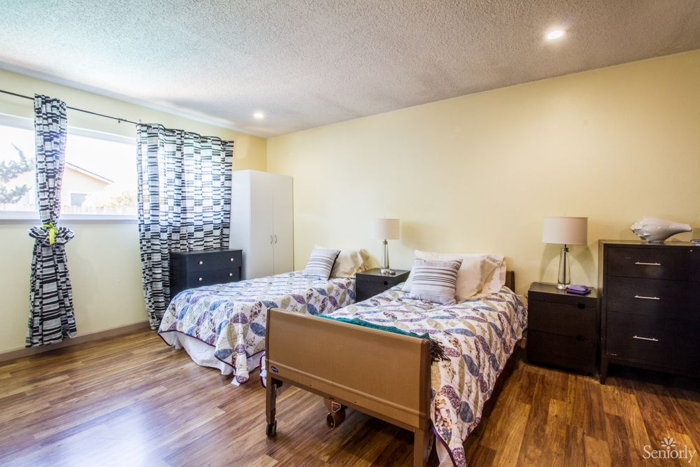 A cozy bedroom with twin beds and modern decor.