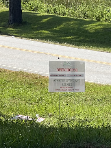 A roadside sign visible in a grassy area, likely conveying important information.