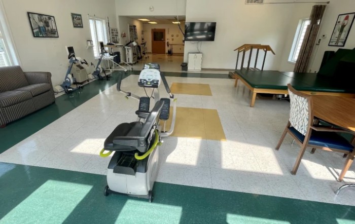 A well-equipped fitness and rehabilitation room with various exercise machines.