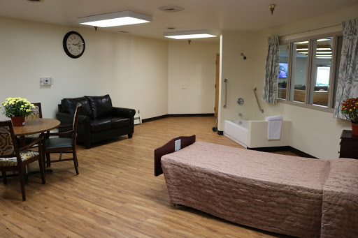 A spacious interior room with seating and a bed, designed for comfort and utility.