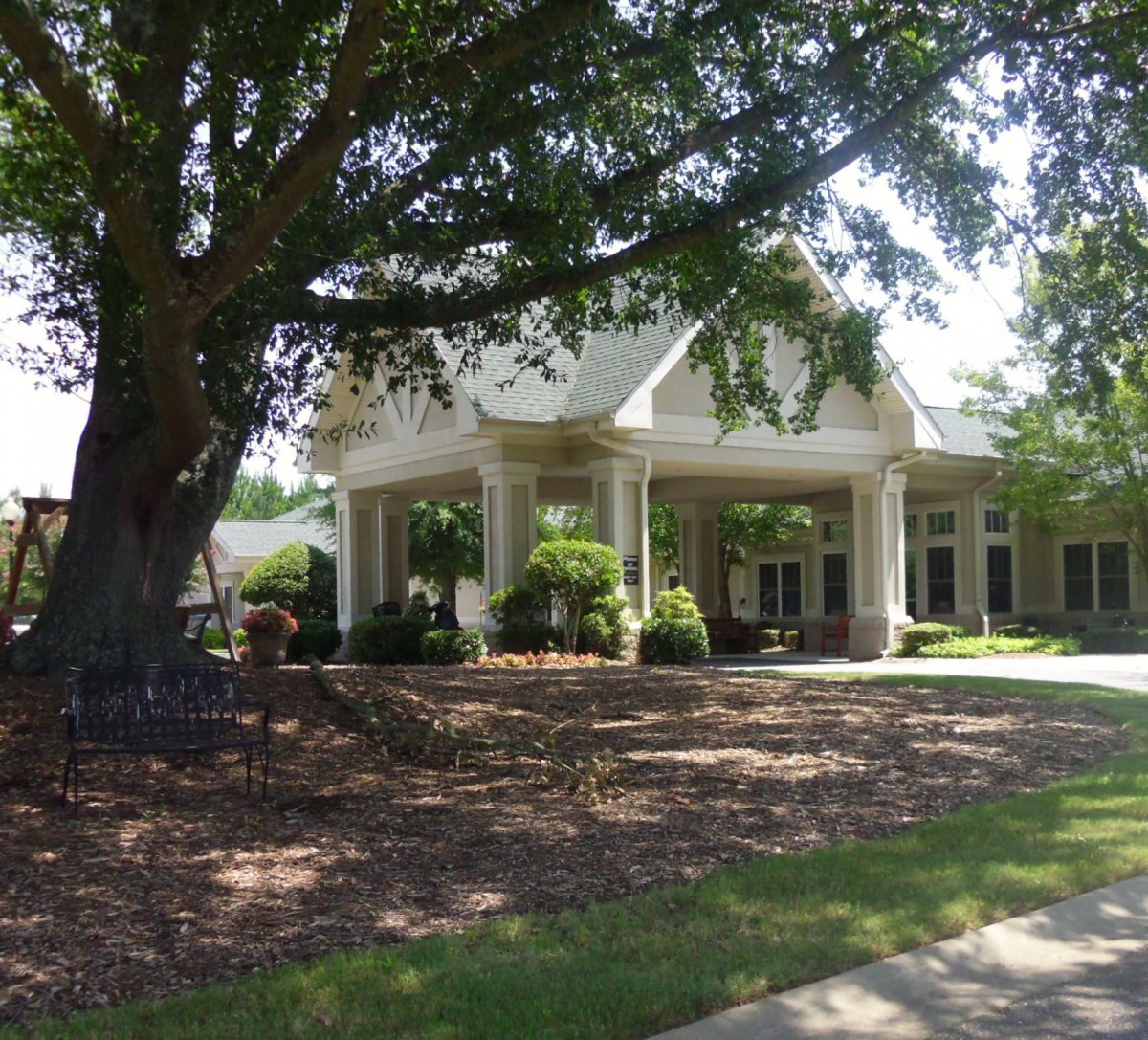 A well-maintained building surrounded by lush greenery and landscaping.