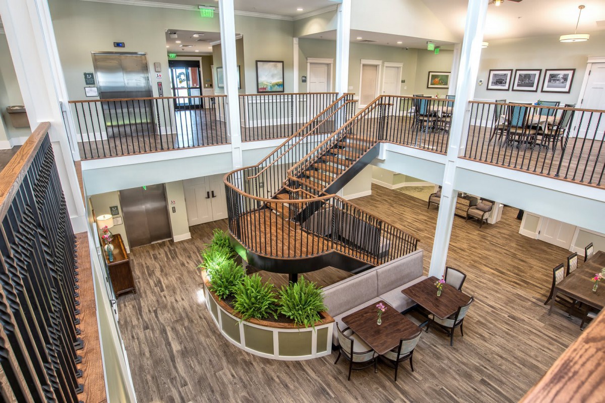 Spacious lobby area with a central staircase and elegant furnishings.