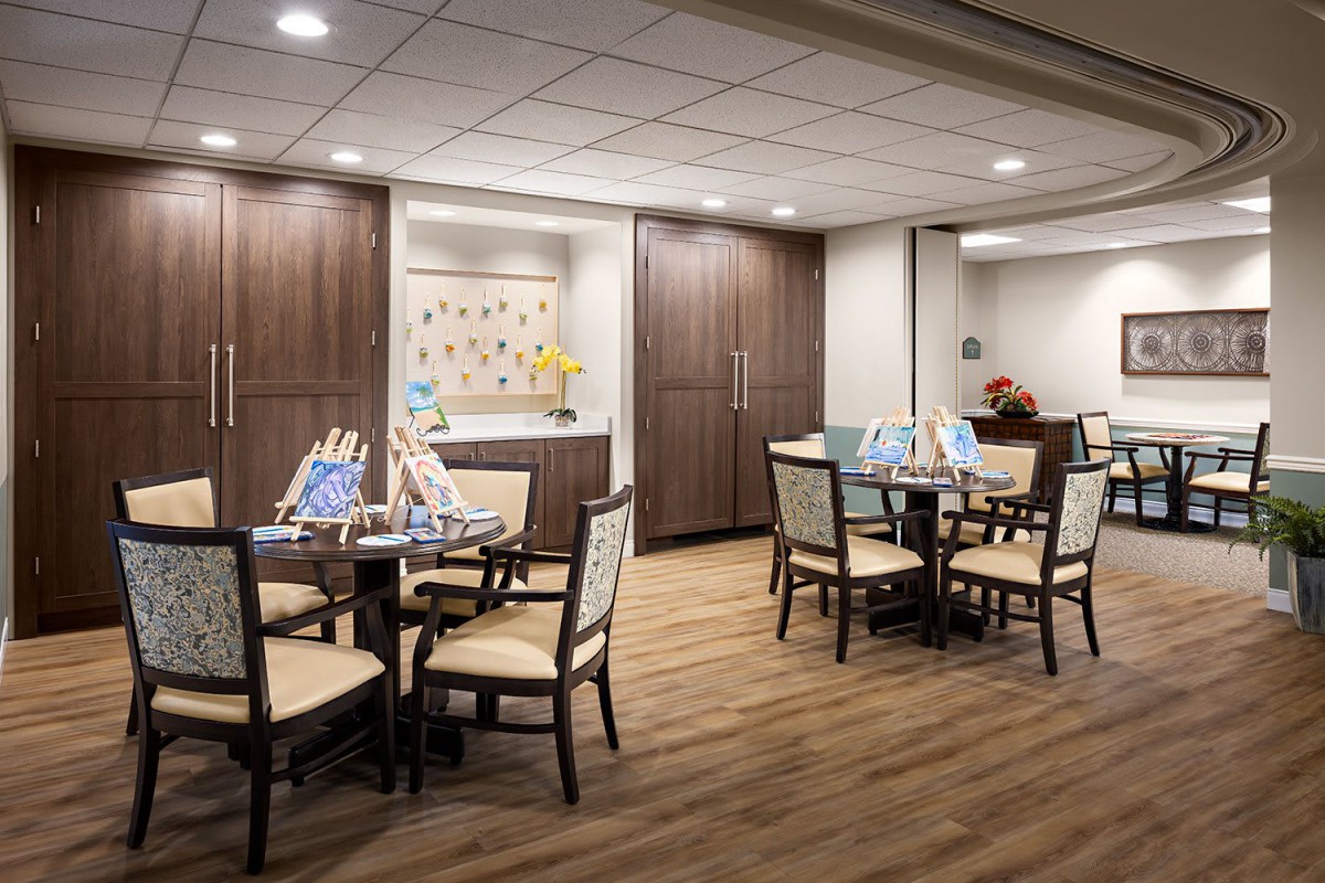A modern dining area with wooden floors and contemporary furniture.