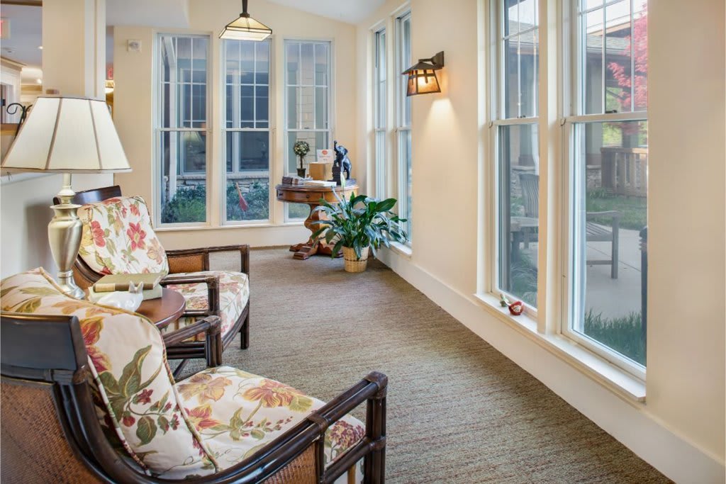 A cozy, bright living space with large windows and comfortable seating.