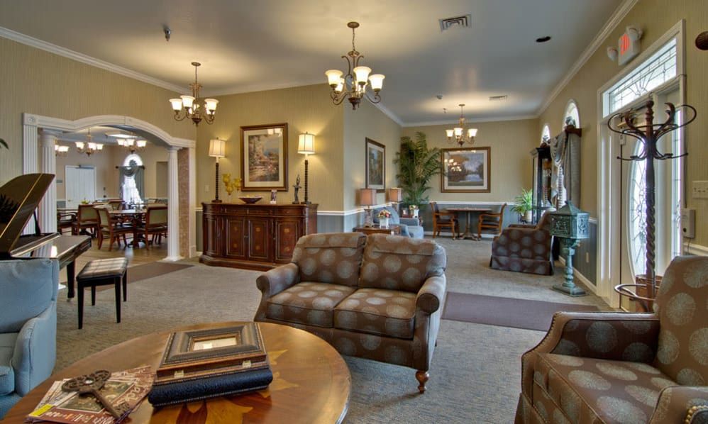 An elegant living room with classical furniture and lighting.