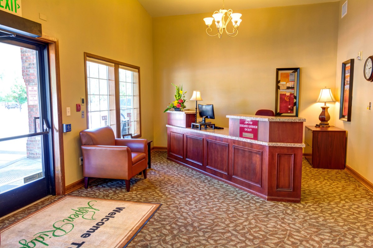 A welcoming reception area with a wooden desk, comfortable seating, and elegant lighting.
