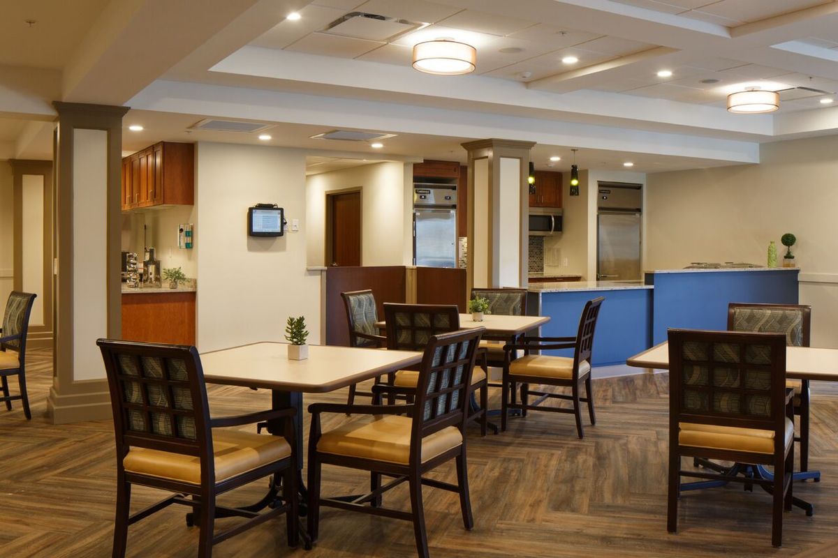 A modern dining area with neatly arranged tables and chairs.