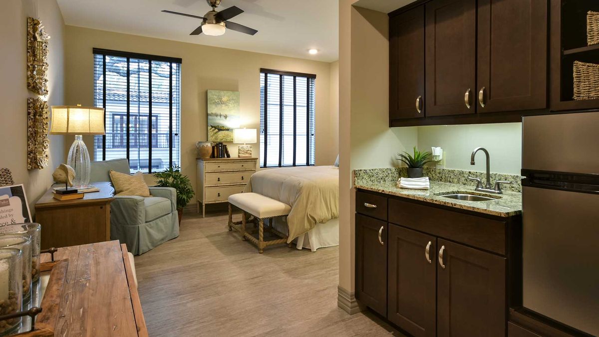 A cozy and modern bedroom with stylish furnishings and warm lighting.