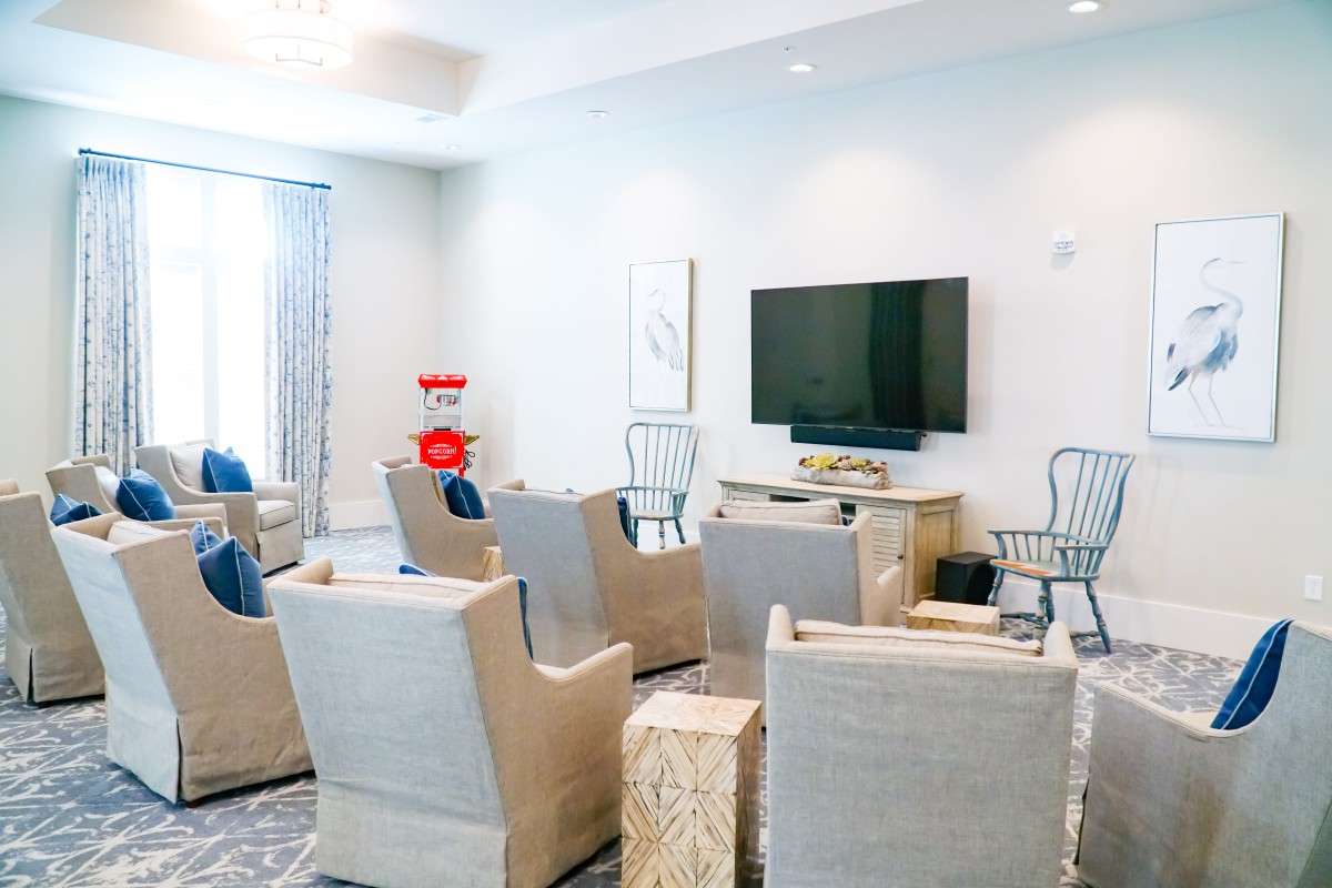 A modern living room with comfortable seating and a mounted television.