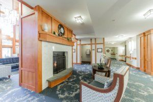 A cozy living room interior with a fireplace and comfortable seating area.