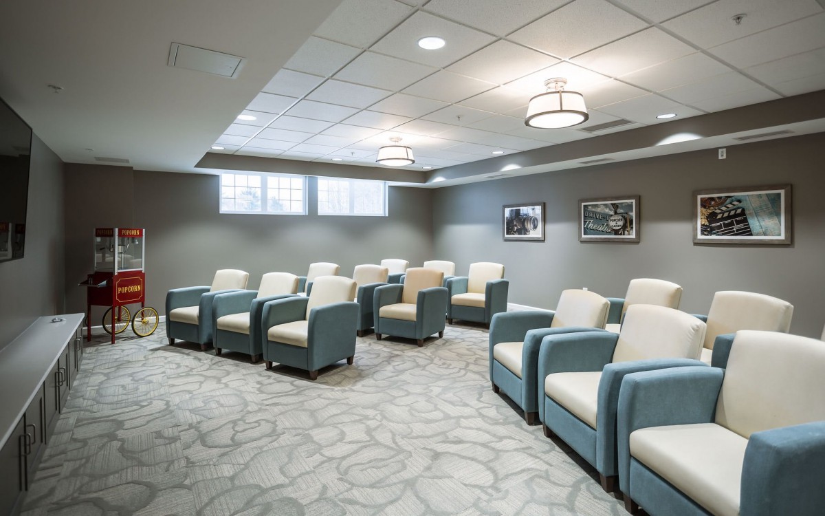 A modern waiting room with comfortable seating and soft lighting.