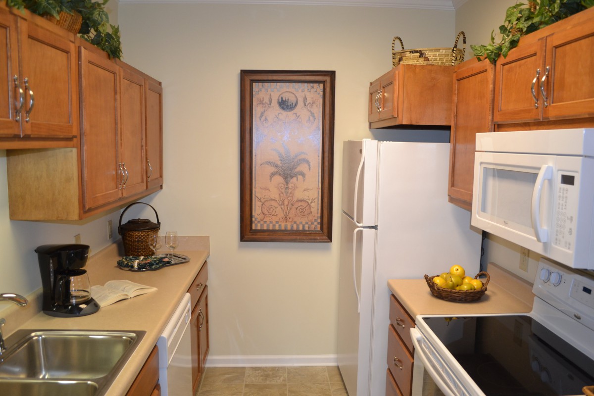 A cozy kitchen with wooden cabinets and modern appliances.