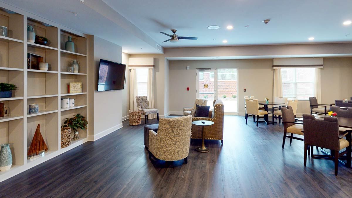 A modern living room with comfortable seating and a large television.