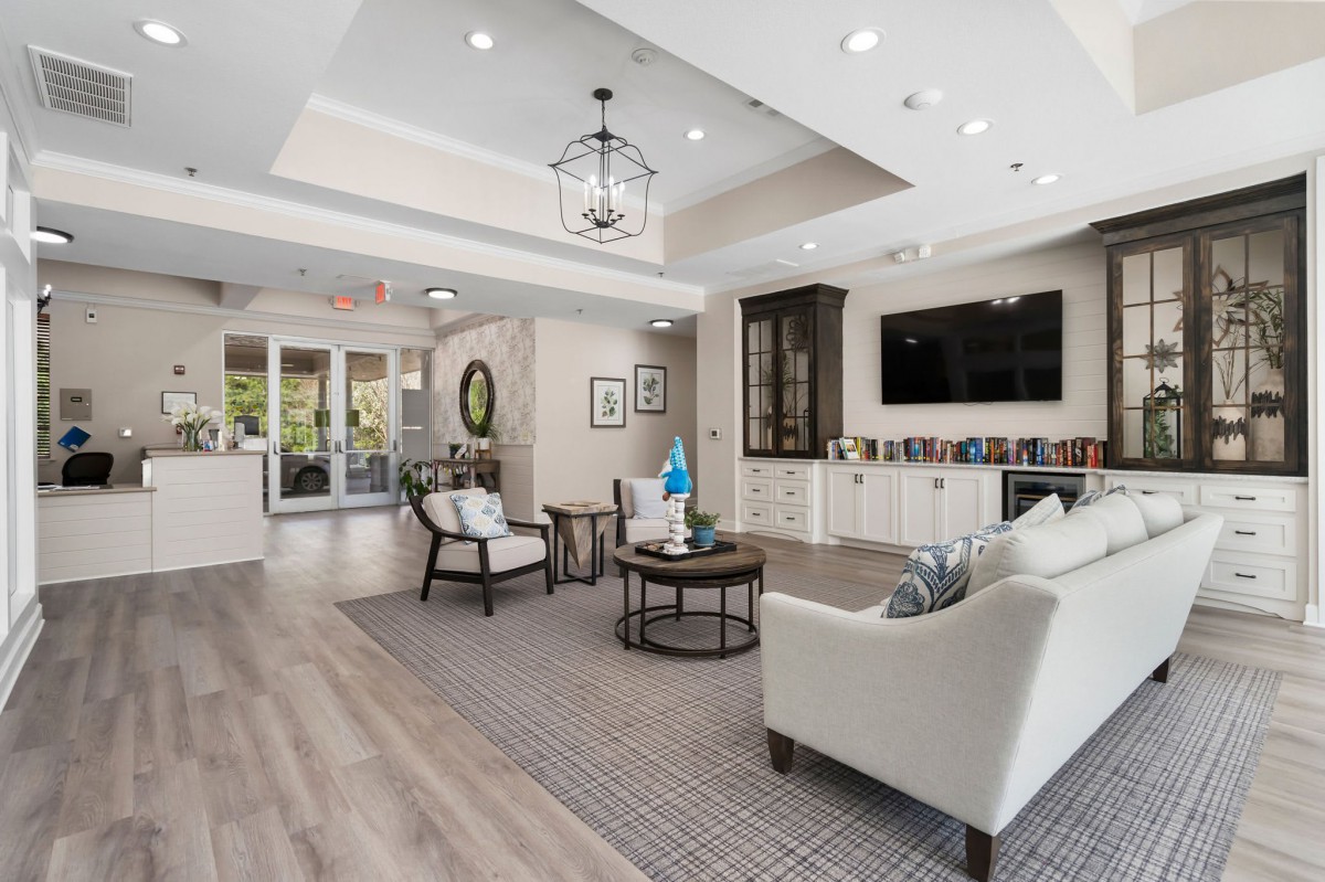 A modern and bright living room with elegant furniture and a television.