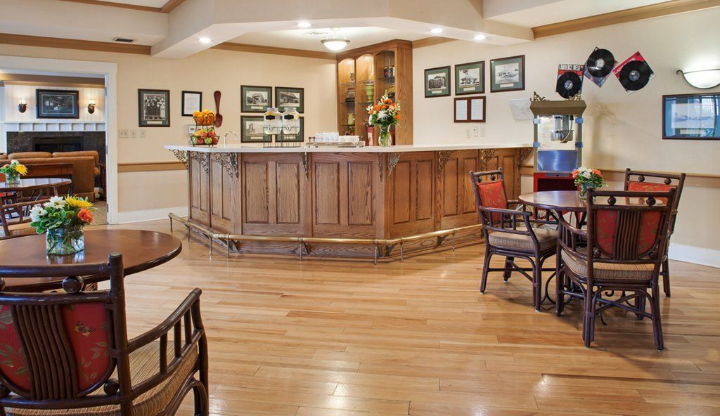A cozy bar with a wooden counter and seating area.