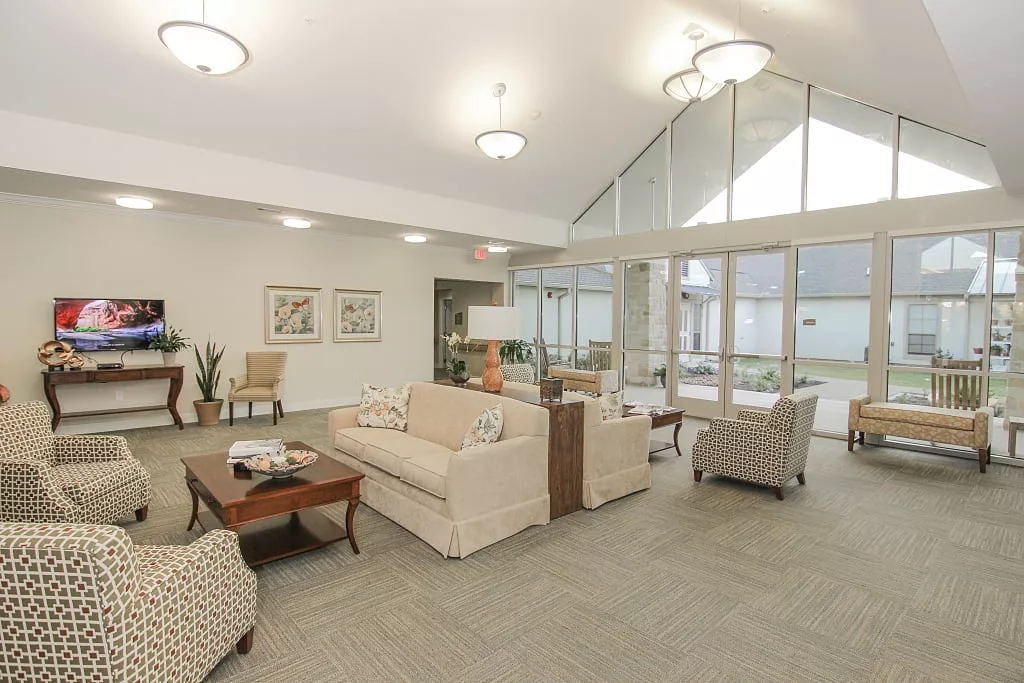 A modern living room with stylish furniture and large windows.