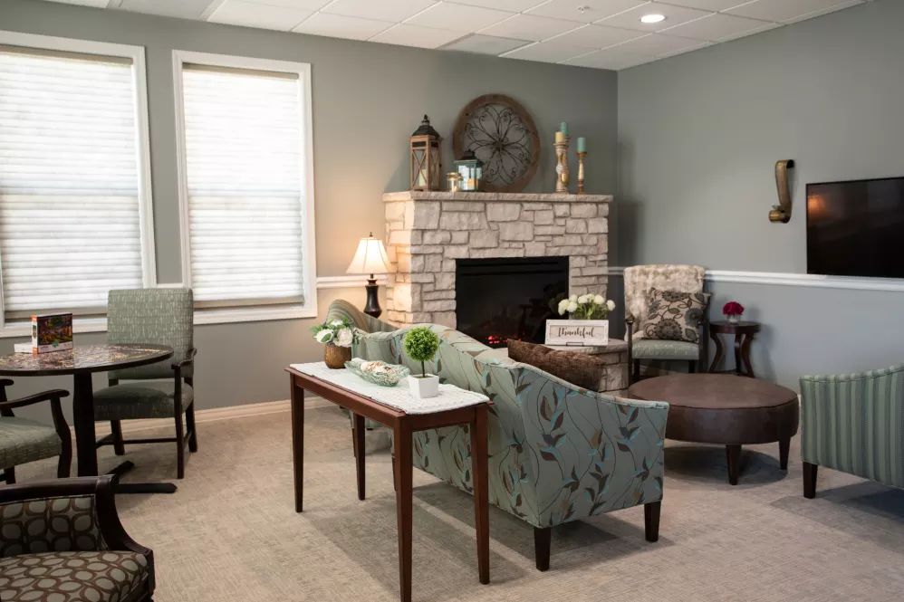 A cozy living room with modern decor and a fireplace.