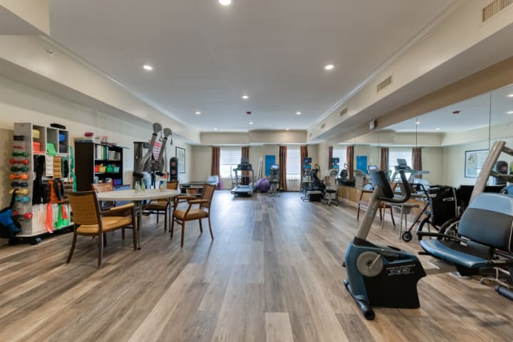 A modern gym with exercise equipment and a spacious workout area.