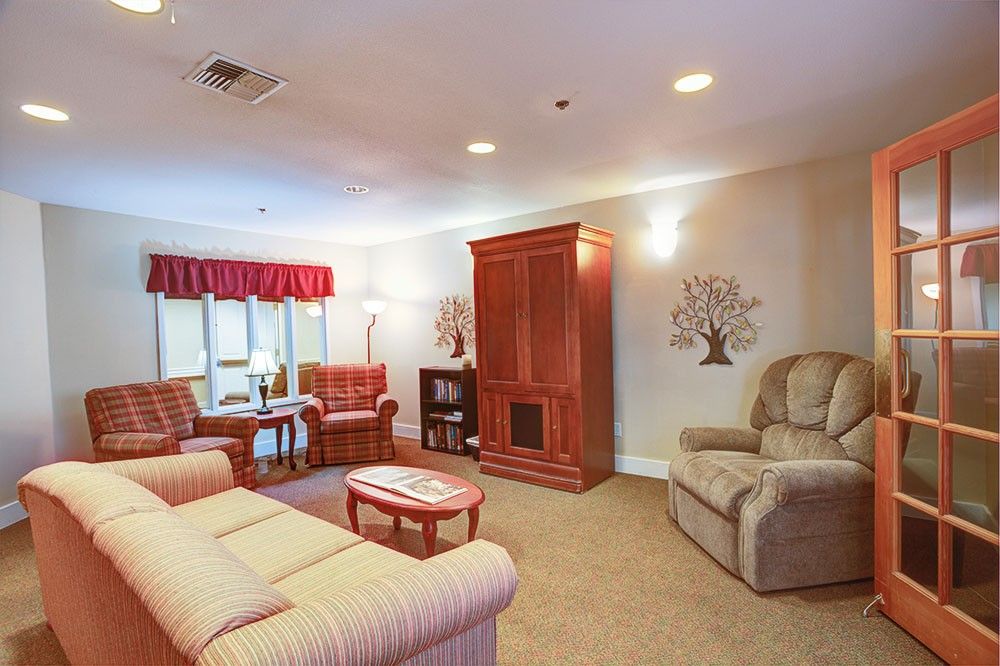 A cozy living room with comfortable seating and traditional furnishings.