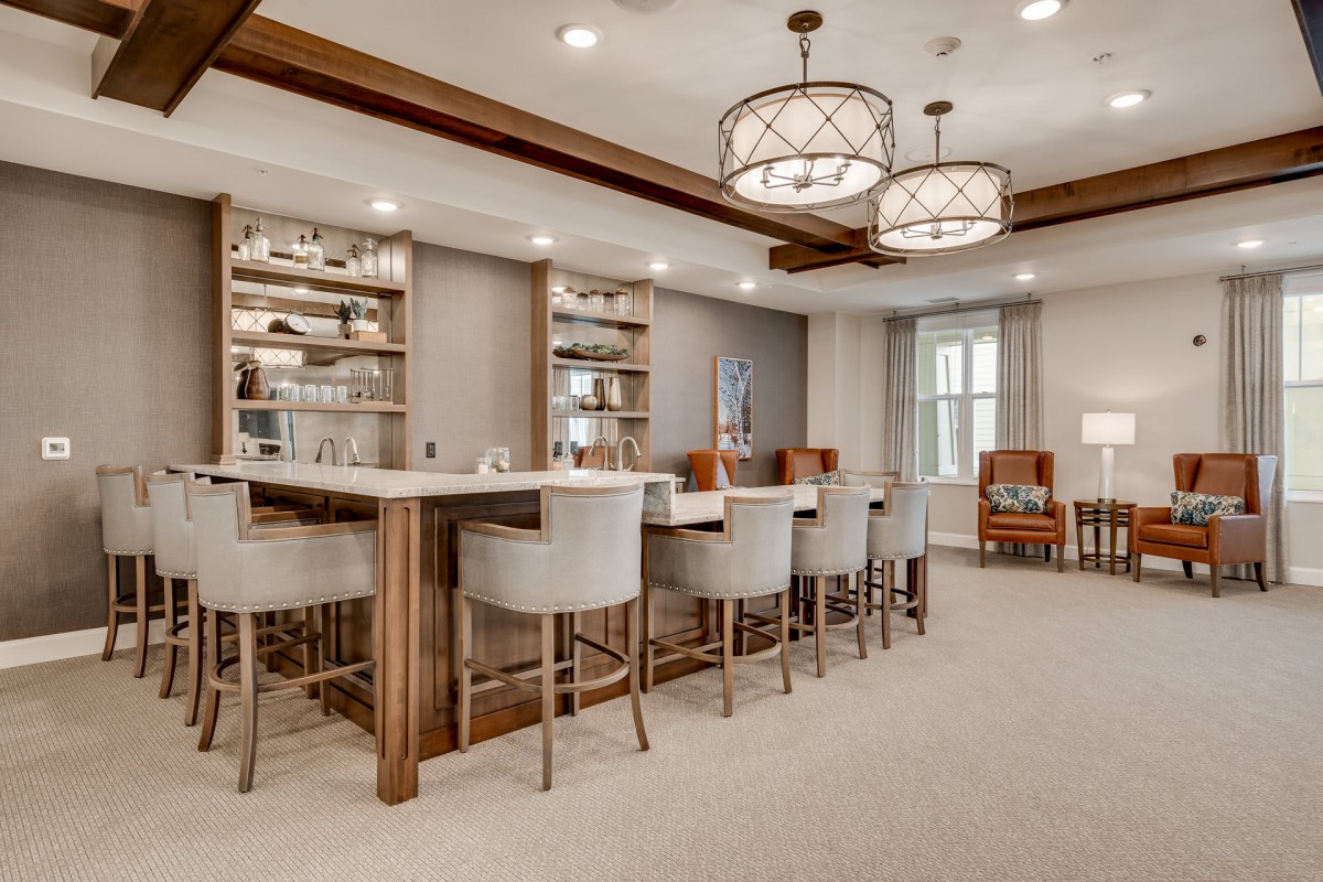 A modern bar area with comfortable seating and elegant lighting.