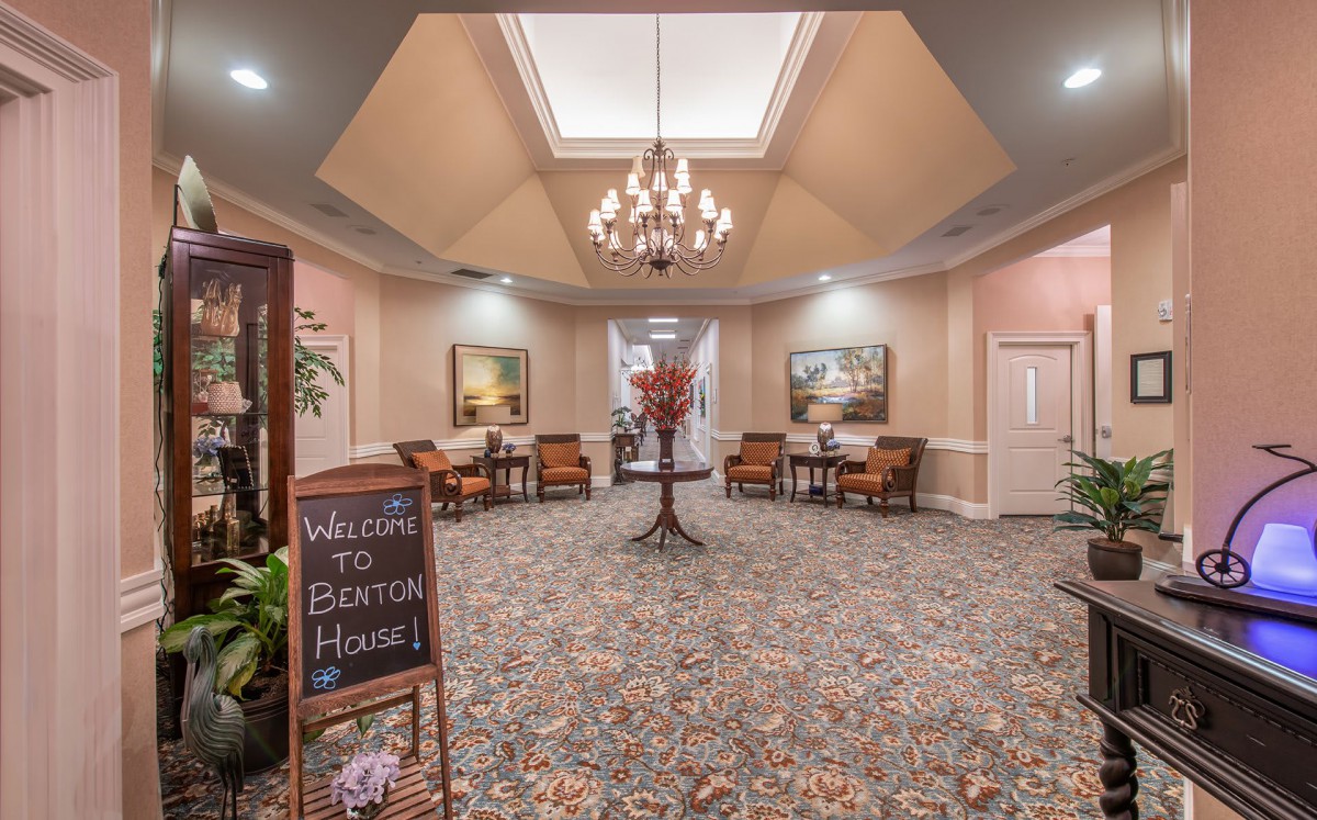 An elegant lobby area with a chandelier, seating, and decorative accents.